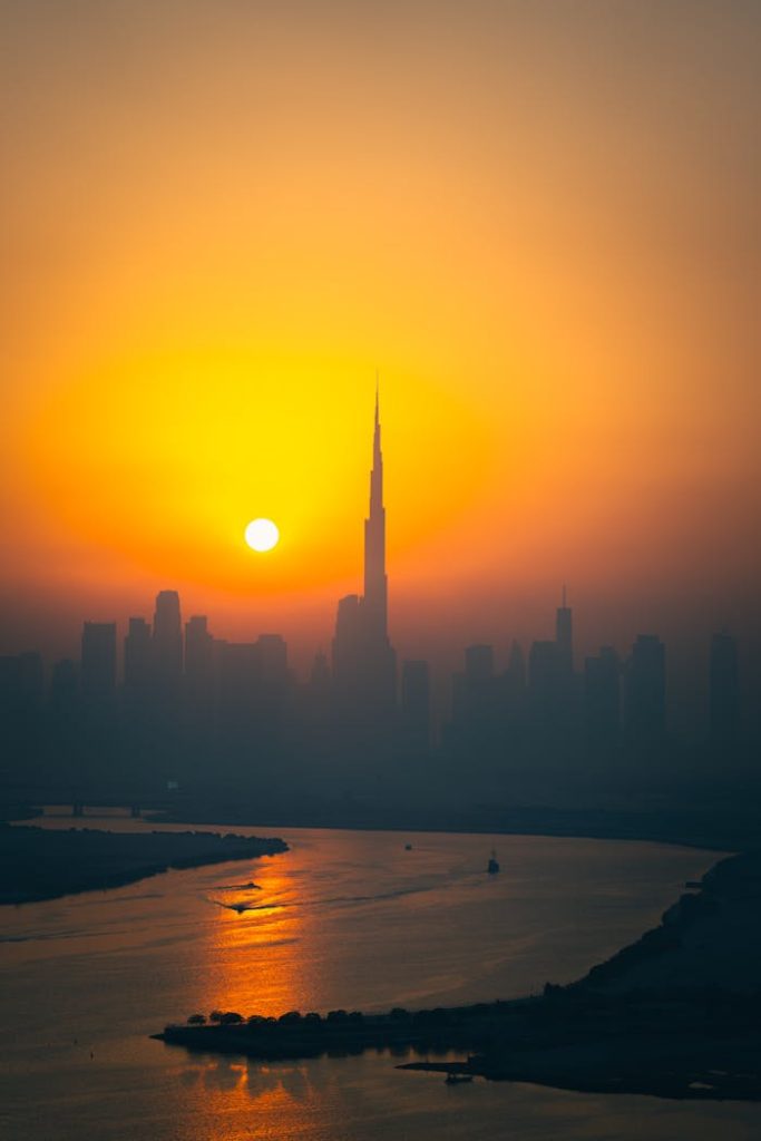 The Art of Drawing Readers In: Your attractive post title goes here A breathtaking view of Dubai skyline with the iconic Burj Khalifa at sunset, reflecting over the water.